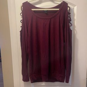 Red sweater with crossed openings on arm